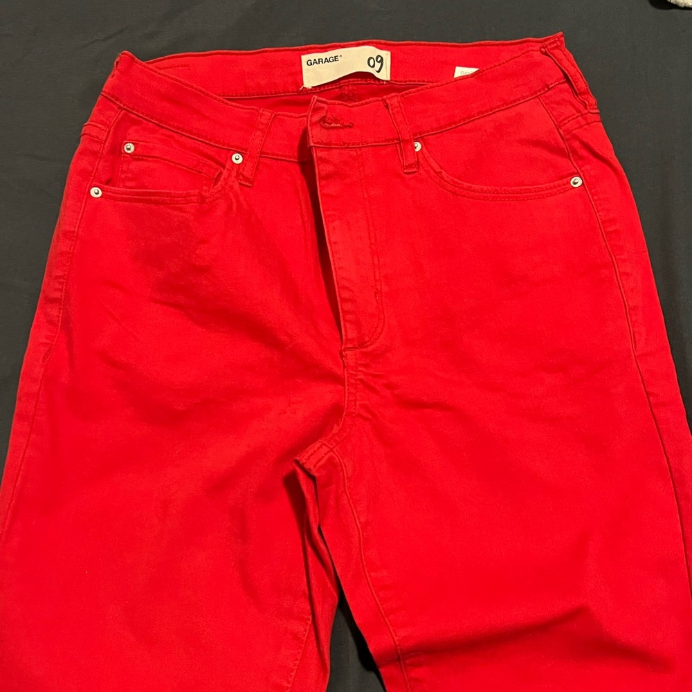 Red skinny jeans with frayed cuffs